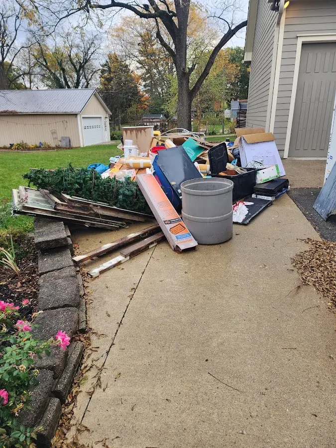 Dumpster being loaded with debris for Estate Cleanout Dumpster Rental in Little Falls